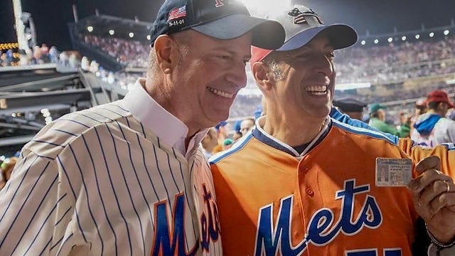 In this undated image, former New York City Mayor Bill de Blasio, left, poses for a photo with Bill DeBlasio, a wine importer from Long Island, at a New York Mets baseball game in New York.