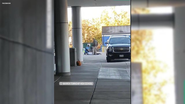 Photo of a blue metal lockers along a nondescript hallway in a typical US High School. No identifiable information included and nobody in the hall.