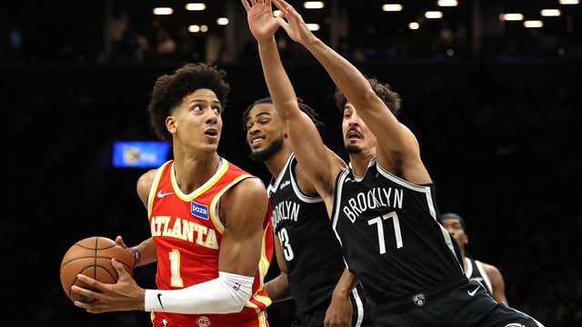 Jalen Johnson #1 of the Atlanta Hawks dribbles against Nic Claxton #33 and Ben Saraf #77 of the Brooklyn Nets during the second half at Barclays Center on October 29, 2025 in New York City.