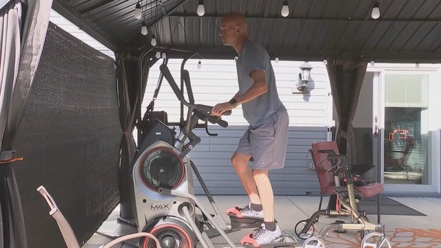 Larry Williams uses an elliptical at his home in Bensalem 