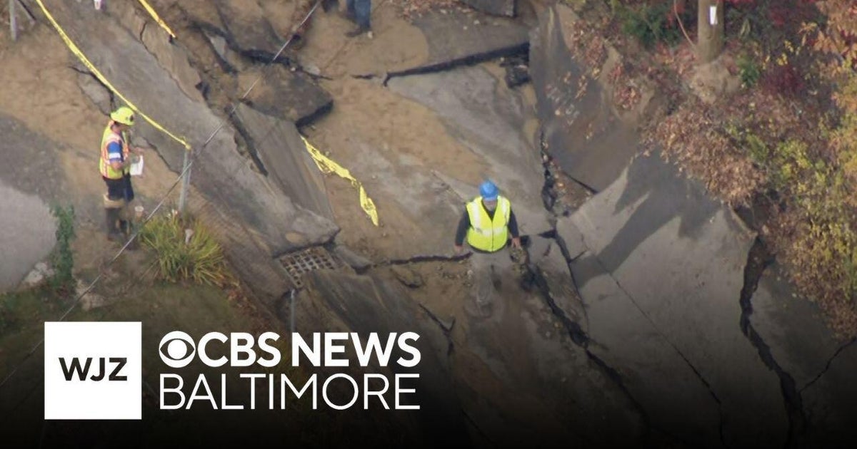 Street caves in after flooding from water main break in Westford - CBS ...