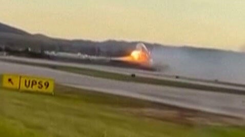 An image capture of video footage distributed by the Associated Press shows flames appearing to come from the left wing of a UPS plane before it crashed in Louisville, Kentucky, Nov. 4, 2025. 