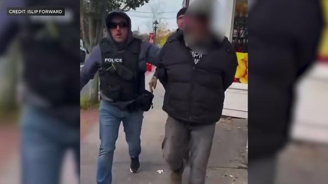 Two federal agents escorting a handcuffed man out of a bakery 