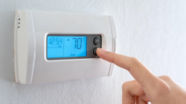 Hand press indoor room thermostat to lower the temp 