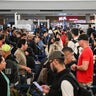 Travelers wait in line at a security checkpoint at George Bush Intercontinental Airport in Houston, Texas, Nov. 7, 2025. 