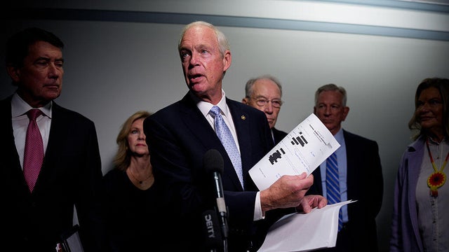 Sen. Ron Johnson of Wisconsin holds up documents while speaking to reporters on Capitol Hill in Washington, D.C., on Oct. 6, 2025, alongside Sens. Bill Hagerty and Marsha Blackburn of Tennessee, Sen. Chuck Grassley of Iowa, Sen. Tommy Tuberville of Alabama, and Sen. Cynthia Lummis of Wyoming. 