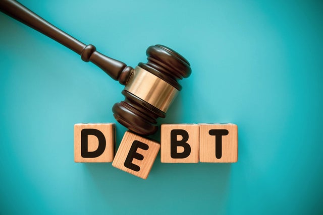 Gavel and wood block with DEBT