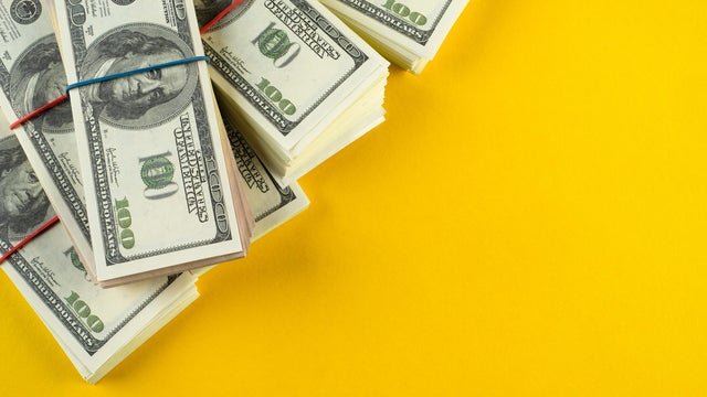 A banknote in US dollars in bundles On a bright background. The concept of finance and economics, investments. Salary, bribe, profit or credit funds. Space for copying. 