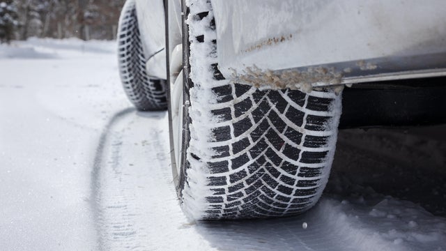 Car winter tires leaving a track in the snow , stock photo 