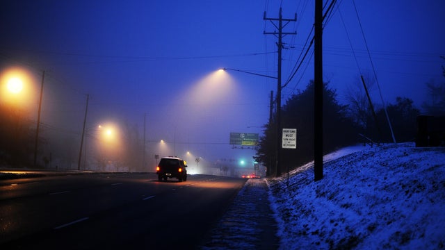 Street lights illuminate through fog and 