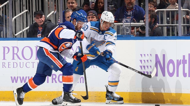 Jonathan Drouin #29 of the New York Islanders and Brayden Schenn #10 of the St. Louis Blues battle for the puck during the first periodat UBS Arena on November 22, 2025 in Elmont, New York. 