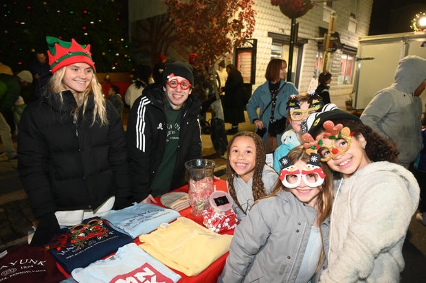 People pose for photos during a holiday event in Manayunk 