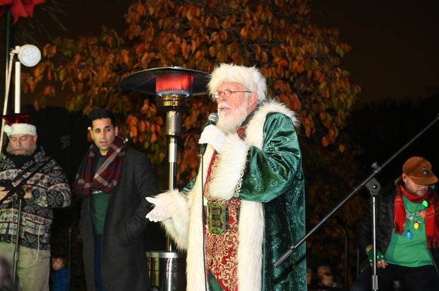 People pose for photos during a holiday event in Manayunk 