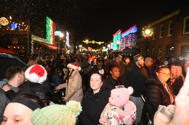 People pose for photos during a holiday event in Manayunk 