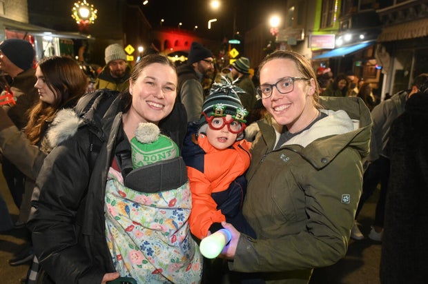 People pose for photos during a holiday event in Manayunk 
