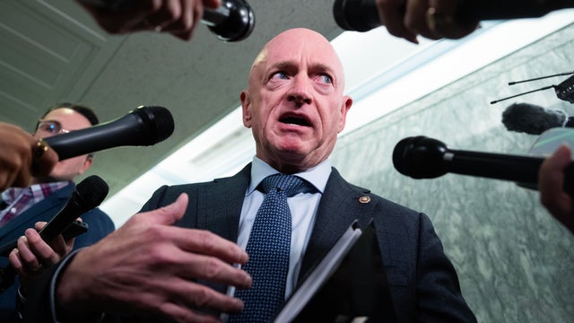 Sen. Mark Kelly talks with reporters in Dirksen building on Tuesday, October 28, 2025. 