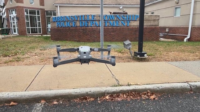 A drone comes in to land near the Robbinsville Township Police Department sign 