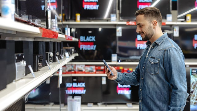 Young man shopping for electronics during a Black Friday sale 