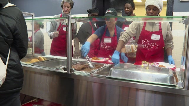 Volunteers serve food at the Bowery Mission in New York City 