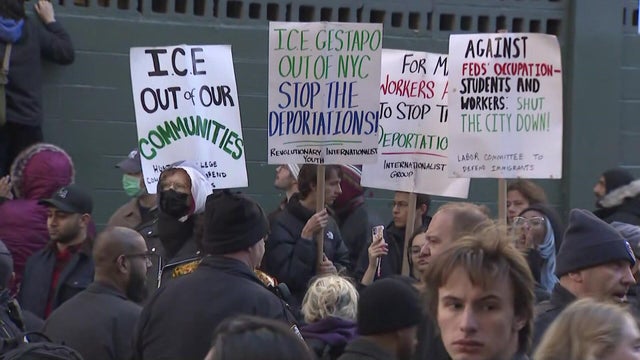 Anti-ICE protesters with signs 