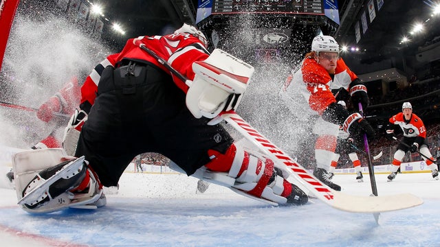 Owen Tippett #74 of the Philadelphia Flyers scores past Jacob Markstrom #25 of the New Jersey Devils for his 100th career goal during the first period of the game on November 29, 2025 at the Prudential Center in Newark, New Jersey. 