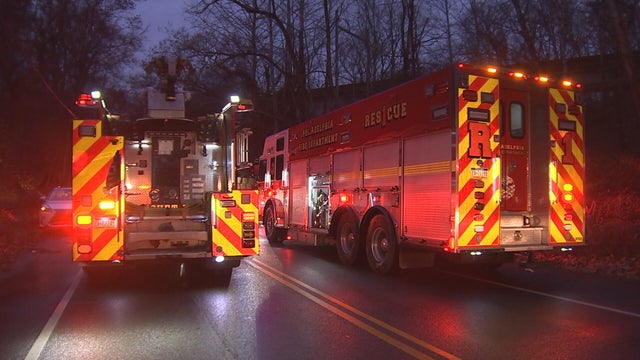 Firefighters and an ambulance are seen at the scene of the crash 
