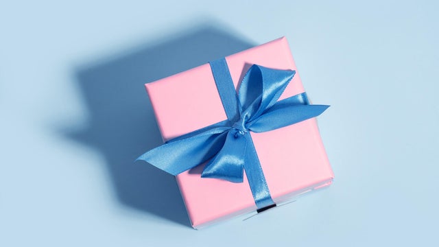Pink Gift Box with blue Ribbon  on Pastel Blue Background as Xmas present, gift, congratulation, Winter Holiday and Black Friday concept. 