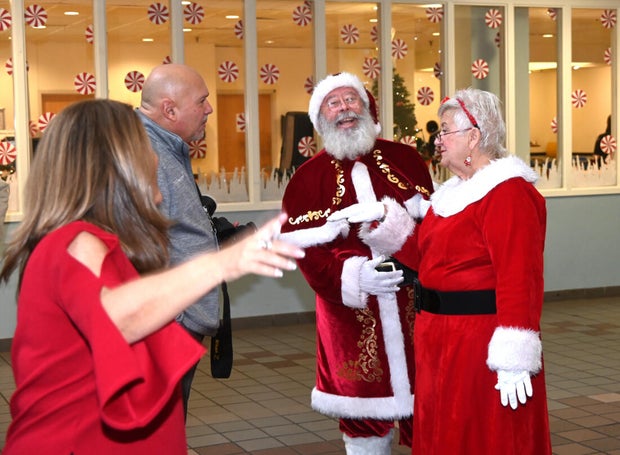 Santa and Mrs. Claus talk to guests
