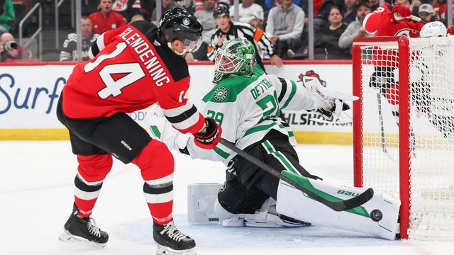 Jake Oettinger #29 of the Dallas Stars makes a save on Luke Glendening #14 of the New Jersey Devils during a game between the Dallas Stars and New Jersey Devils at Prudential Center on December 3, 2025 in Newark, New Jersey. 