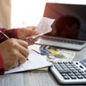 Men and documents that calculate home office expenses 