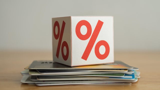 Close up interest rate symbol box on many credit card white background. 