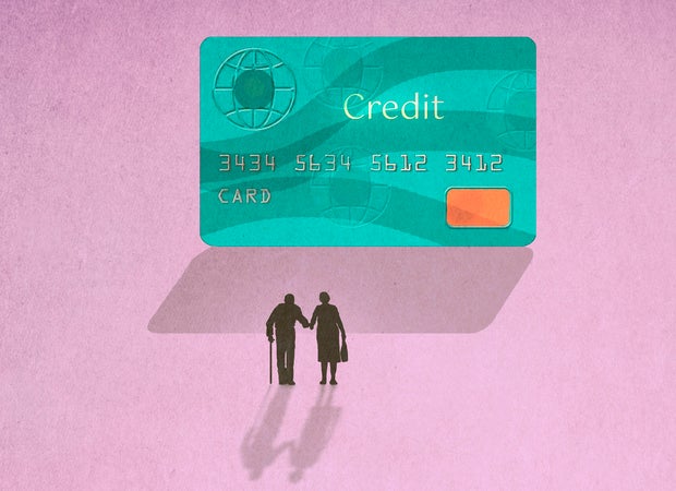 Silhouette of senior couple walking towards large credit card