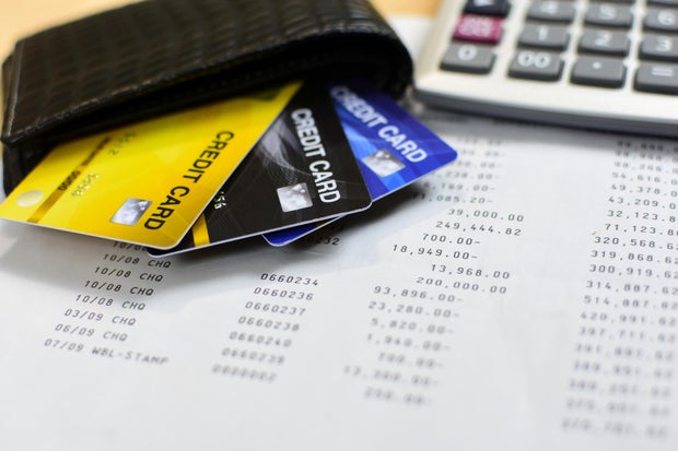 Credit cards in leather wallet and calculator