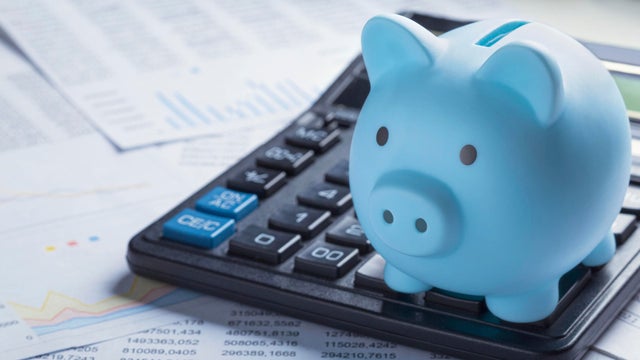 pig money box for money on background with calculator and financial charts. Investment and capital accumulation concept 