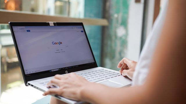 In this photo illustration, A woman browses the Google 