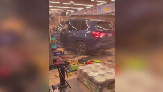 Firefighters are seen at the scene of a fire at a Ace Hardware 