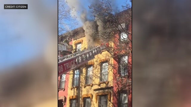 Smoke pours from two windows on fourth floor of apartment building 
