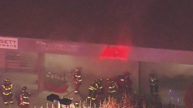 Firefighters are seen at the scene of a fire at a Ace Hardware 