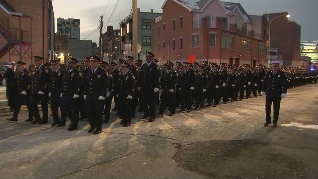 Police officers are lined up in the street before the viewing 