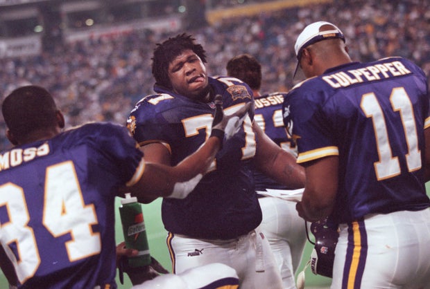 GENERAL INFORMATION: Korey Stringer photos from the 2000 seasonIN THIS PHOTO: Minnesota Vikings right tackle Korey Stringer, center, slaps hands with wide receiver Randy Moss, left, on the sidelines as he comes off the field during a game against Arizon