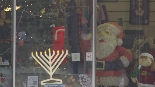 A menorah decoration seen on a business's window 