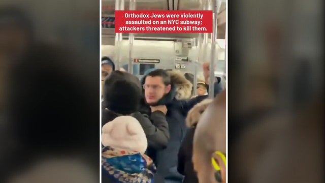 A man grabs another man by the neck 