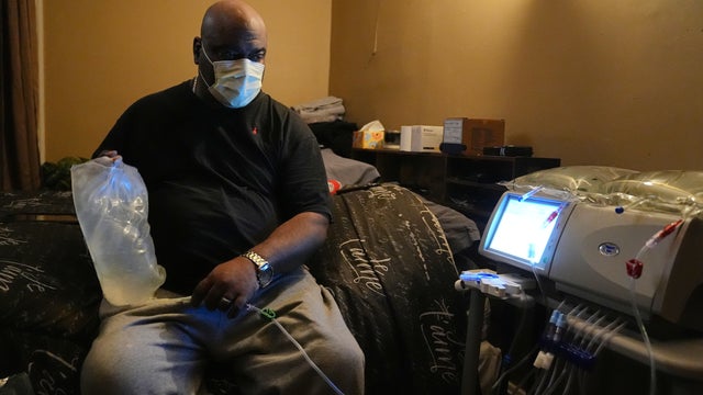Ahmad Collins, a city government worker and former Penn State linebacker, prepares for his nightly dialysis at his home in Harrisburg, Pennsylvania, in December 2025 