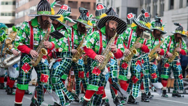 Performers seen playing music instrument during the Philadelphia Mummers Parade 
