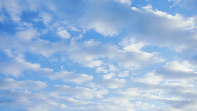 Partly cloudy sky with blue and white clouds. Soft and serene sky. 