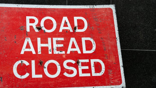 Closeup of a Road Ahead Closed sign 