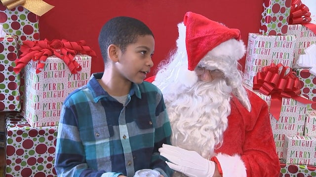 A little boy talks to Santa at an event at Our Mother of Consolation school in Chestnut Hill 