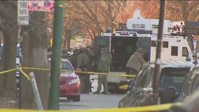 a close-up view of a police vehicle with blue lights patrolling near a public park with the windows and doors closed 