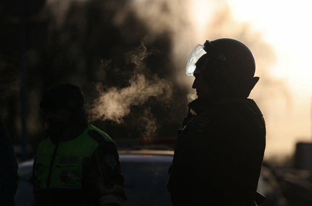 Law enforcement officers work near the site of a blast in Moscow 