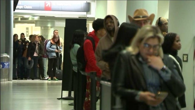 People wait in line at Philadelphia International Airport 